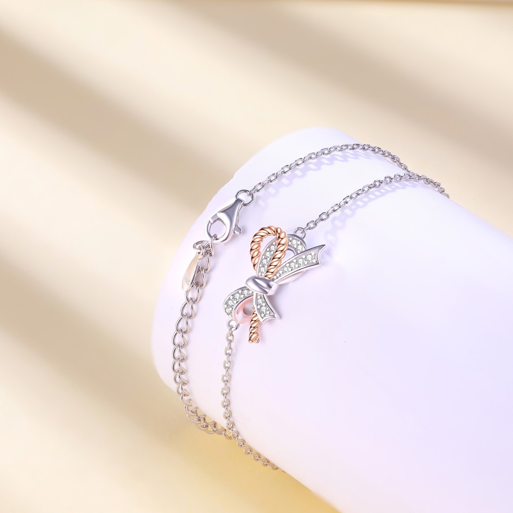 Ribbonique - Two-Toned Moissanite Bracelet with Decorative Bow and Pave Accents